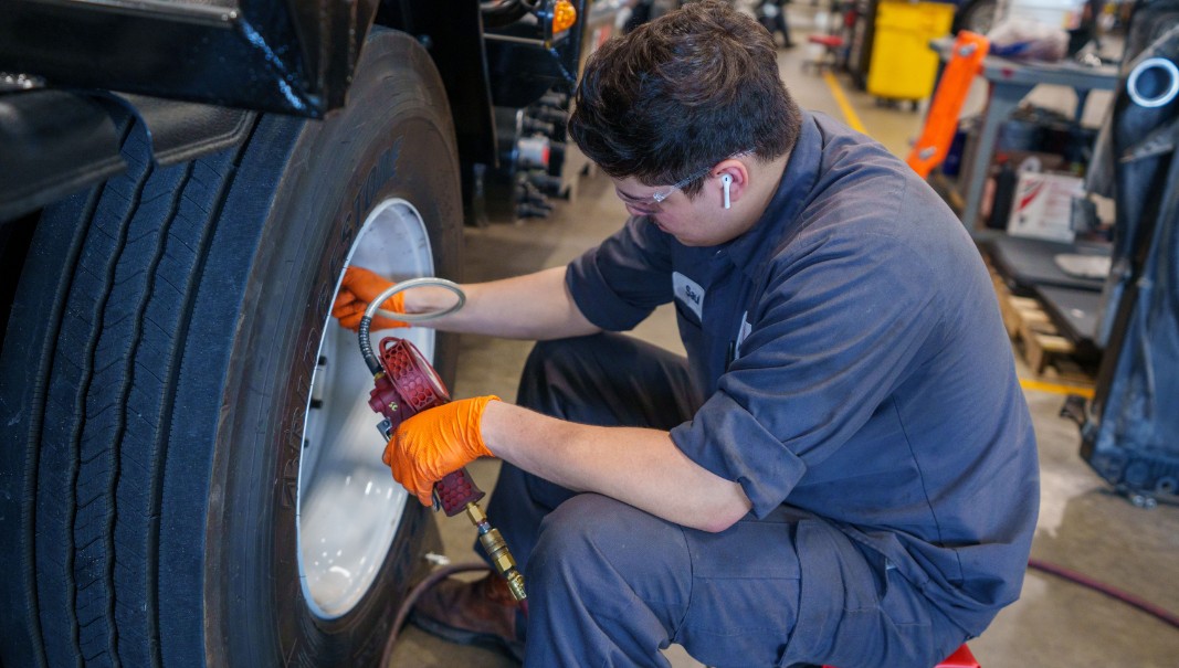 Technician Checking Tire